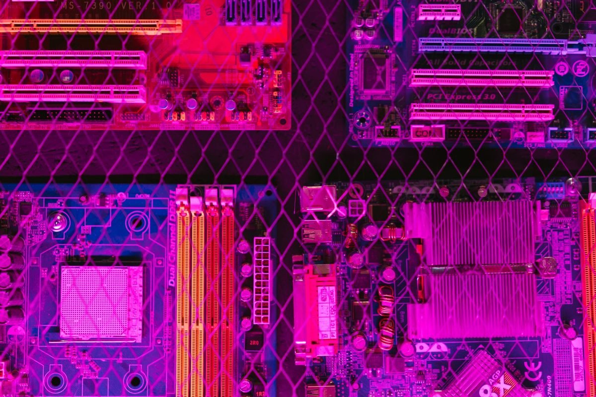 Top-down view of a motherboard lit in pink and purple