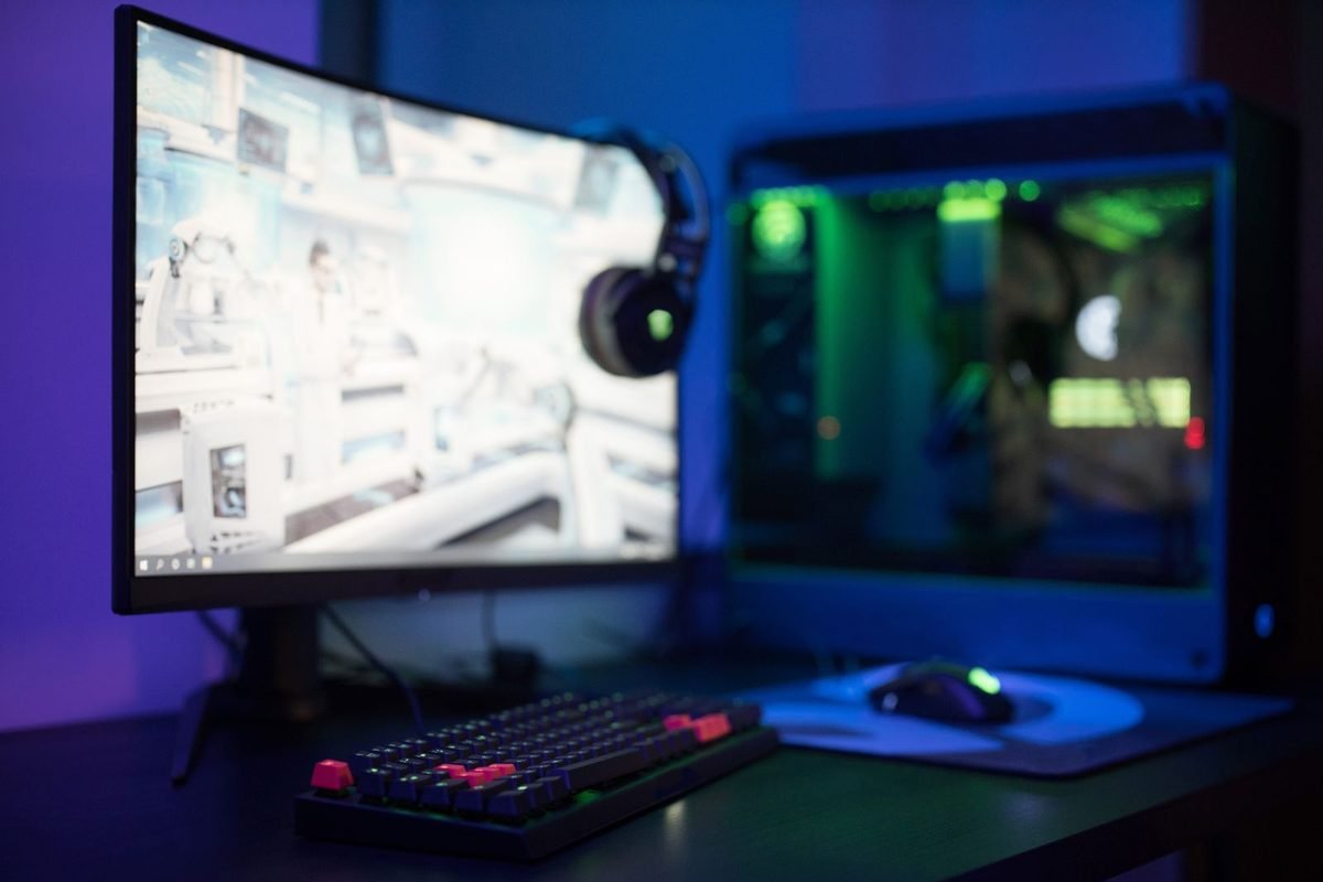 Gaming setup with a monitor, RGB keyboard and a glowing computer case