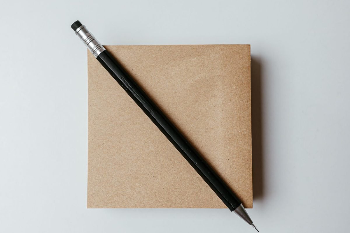 Notepad and pen on a white desk ready for notes