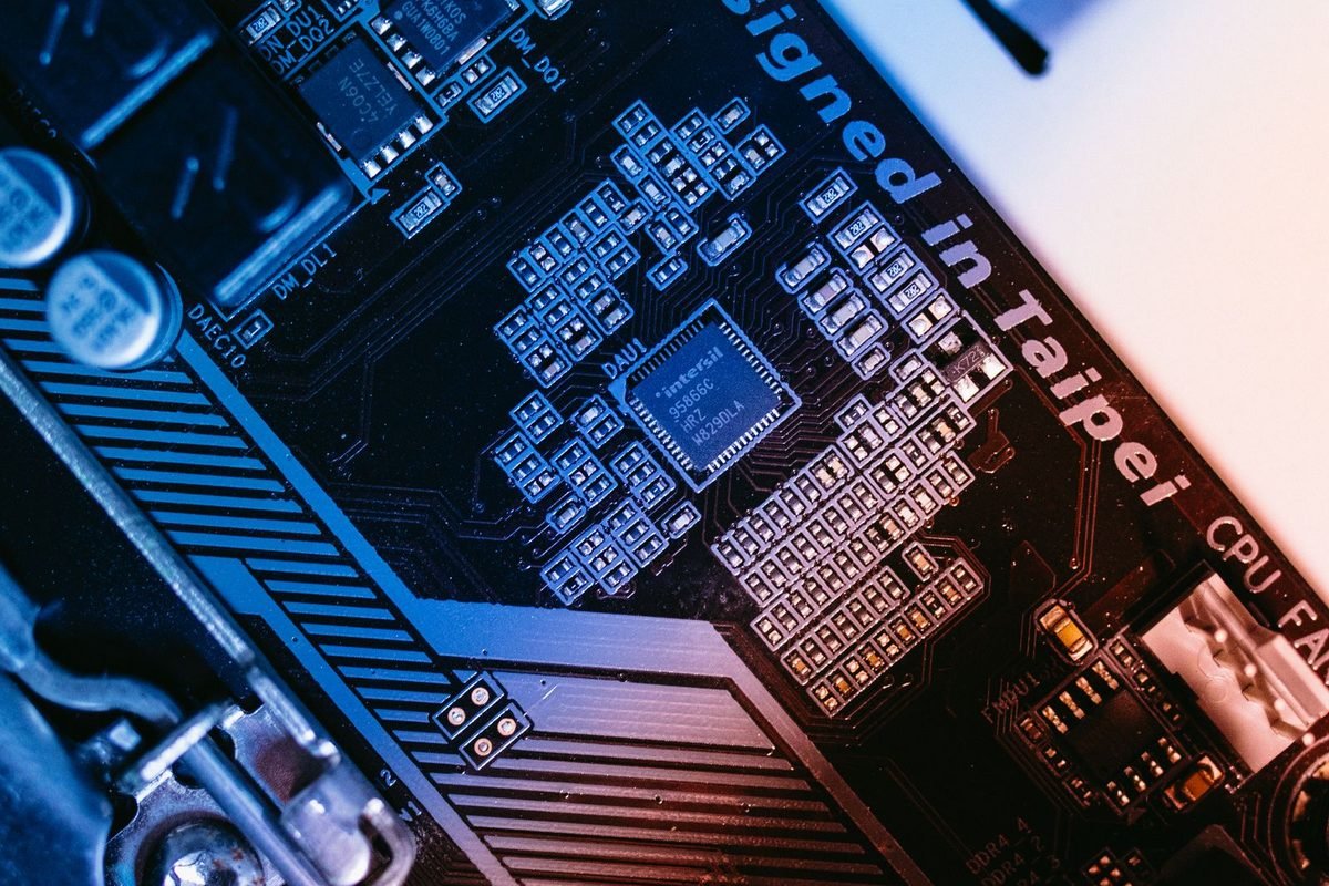 Macro view of a blue computer motherboard with chips and circuits