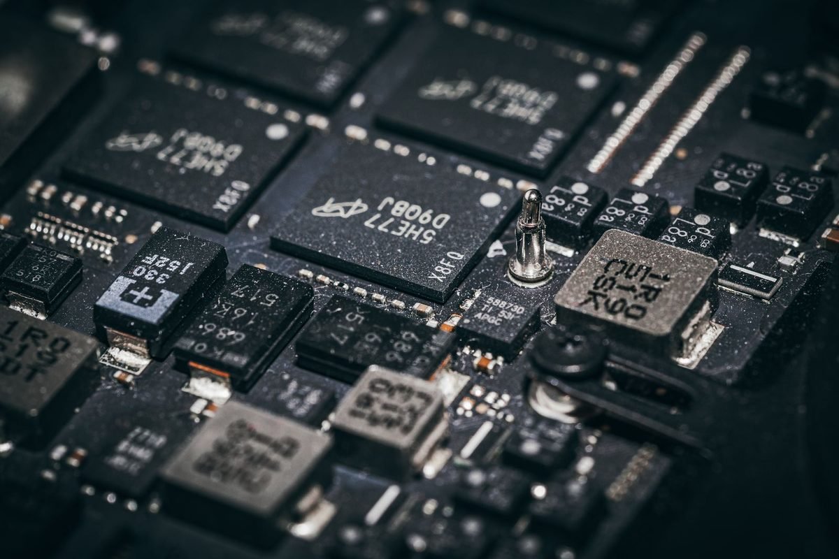 Close-up of electronic chips and components on a dark circuit board