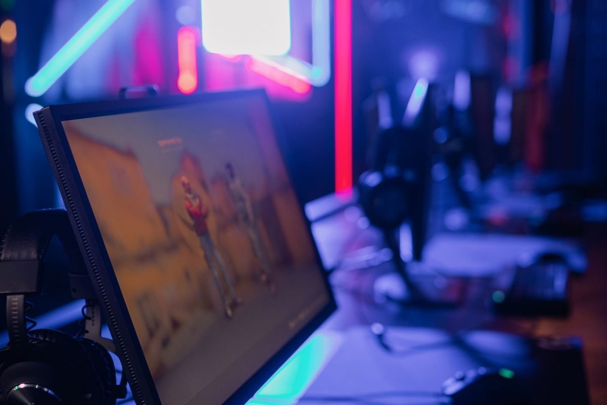 Gaming desk with a monitor, keyboard and neon lighting