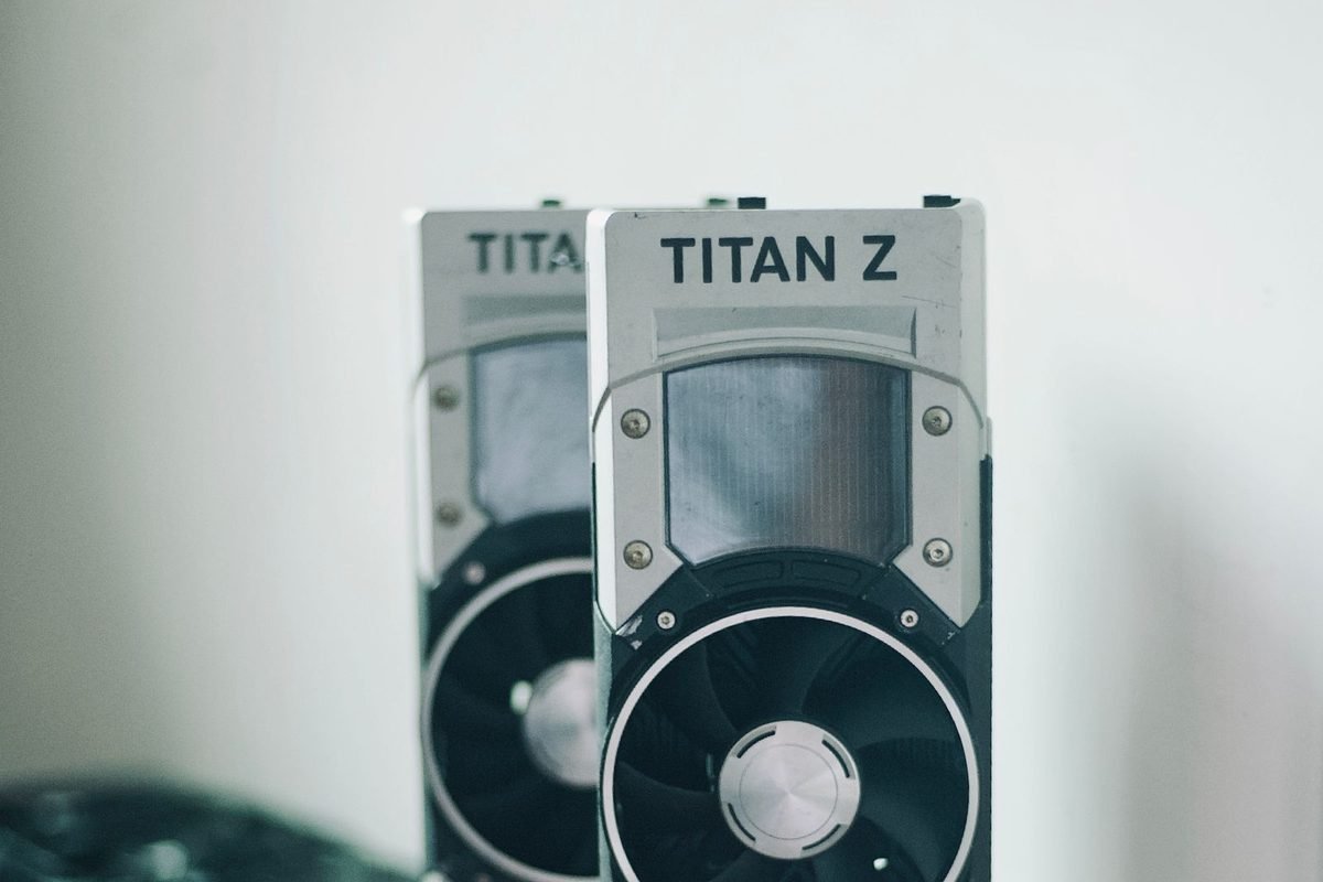 Two NVIDIA Titan Z graphics cards standing on a wooden table